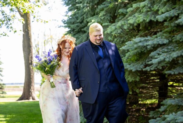 Man and bride walking outside with custom suit