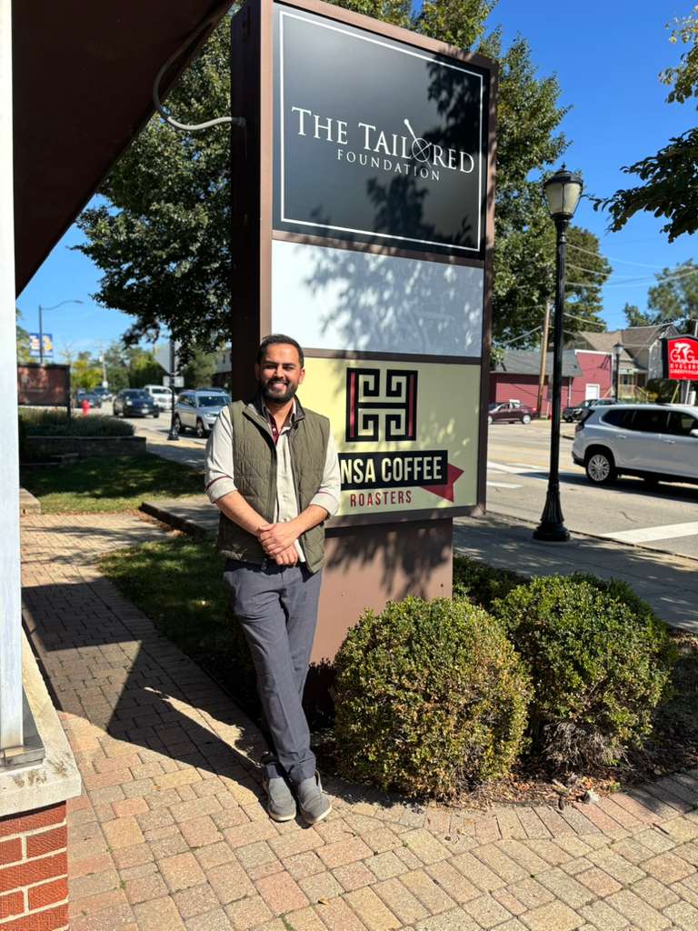 WhatsApp Image 2025-10-02 at 17.45.01_a18c42ea Aarish standing at the tailored foundation sign