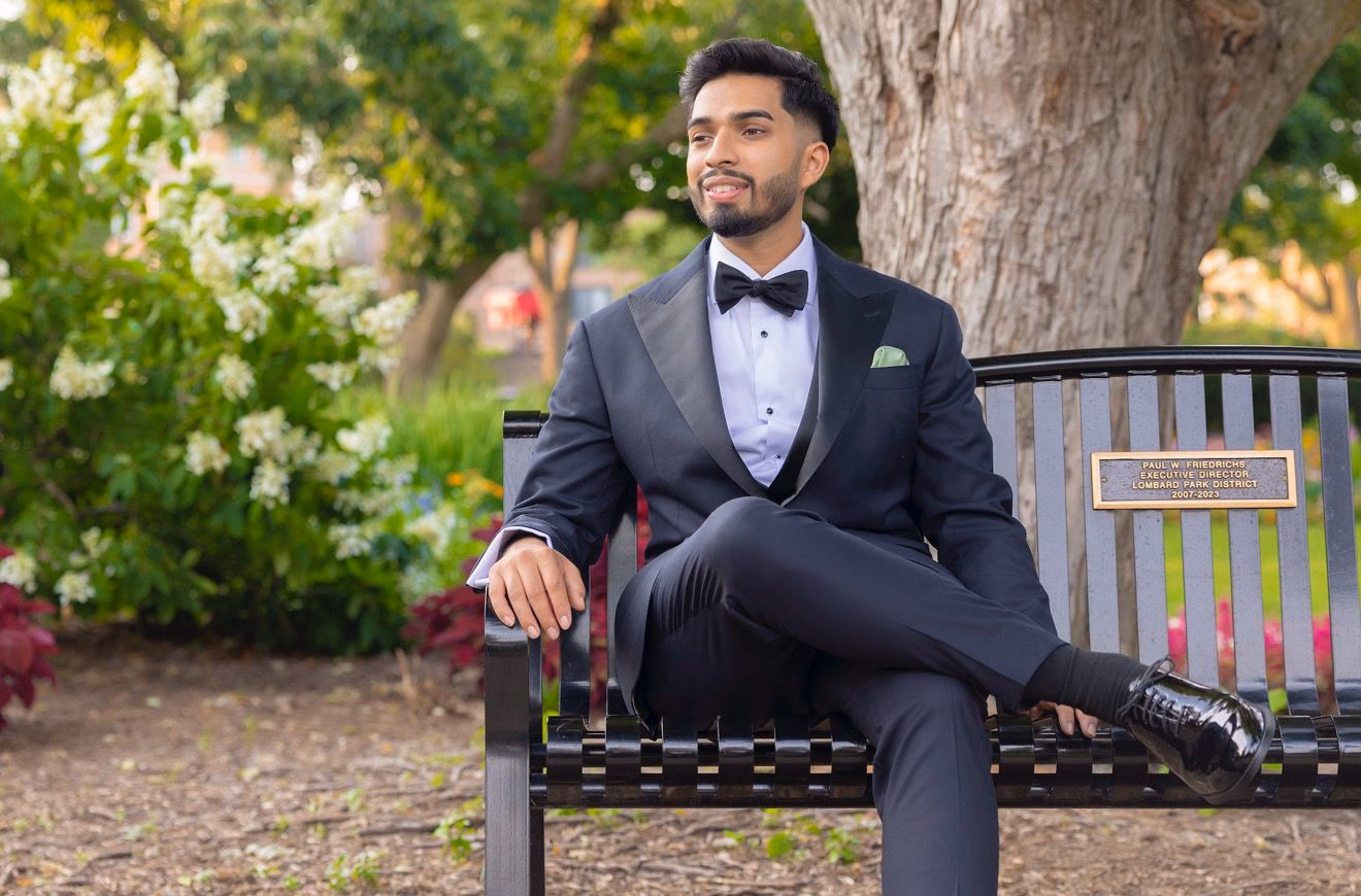 Man stting on Bench wearing custom suit