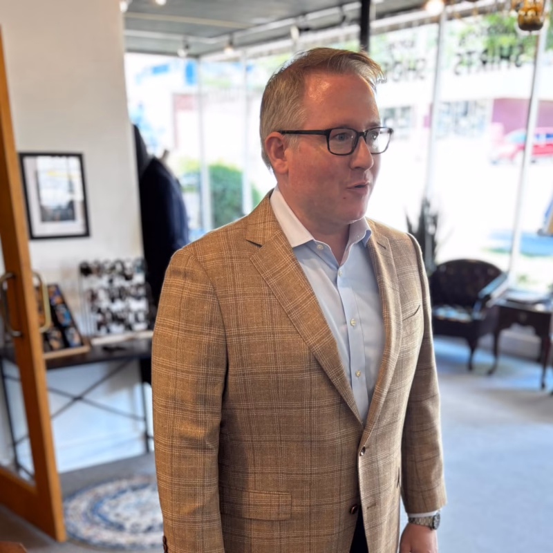 Man wearing a custom tan windowpane check sport coat in the studio