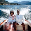 Najuan Brown wearing a custom white double-breasted suit by The Tailored Foundation while riding on a boat with his wife in Lake Como, Italy.